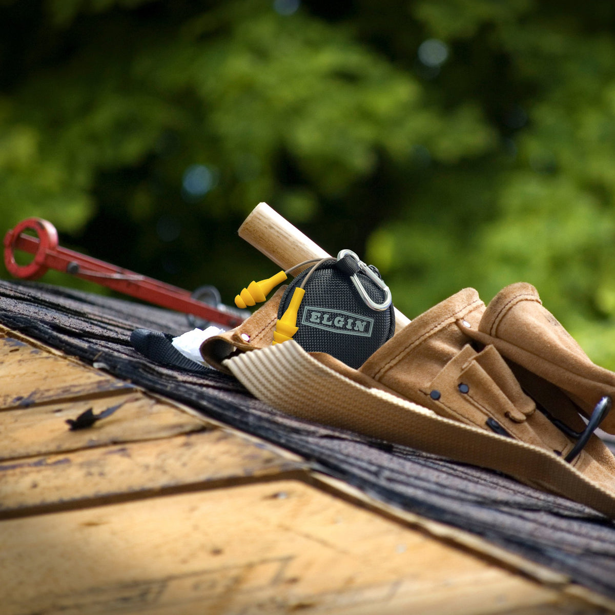A roofers tool belt with the Elgin Ruckus Wired In-Ear Earbuds with mic